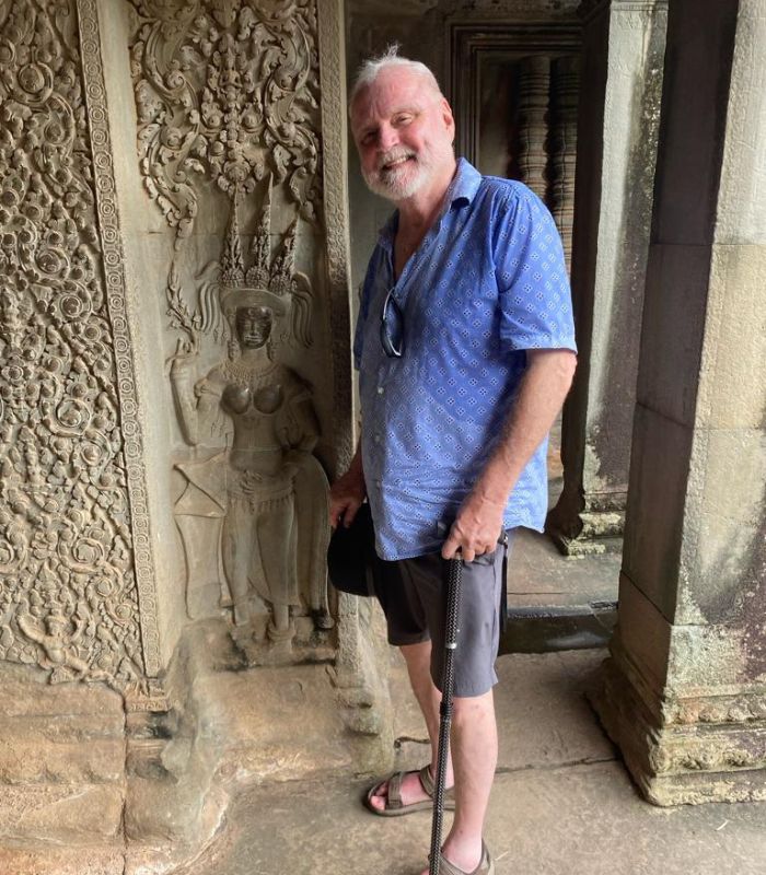 Dan by one of the engraved walls at Angkor Wat Dan by one of the engraved walls at Angkor Wat