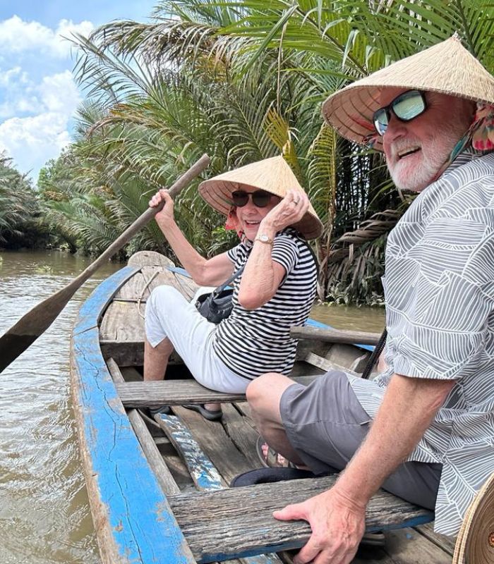 Isobel and Dan floating down the Meking Delta Mekong Delta, Vietnam