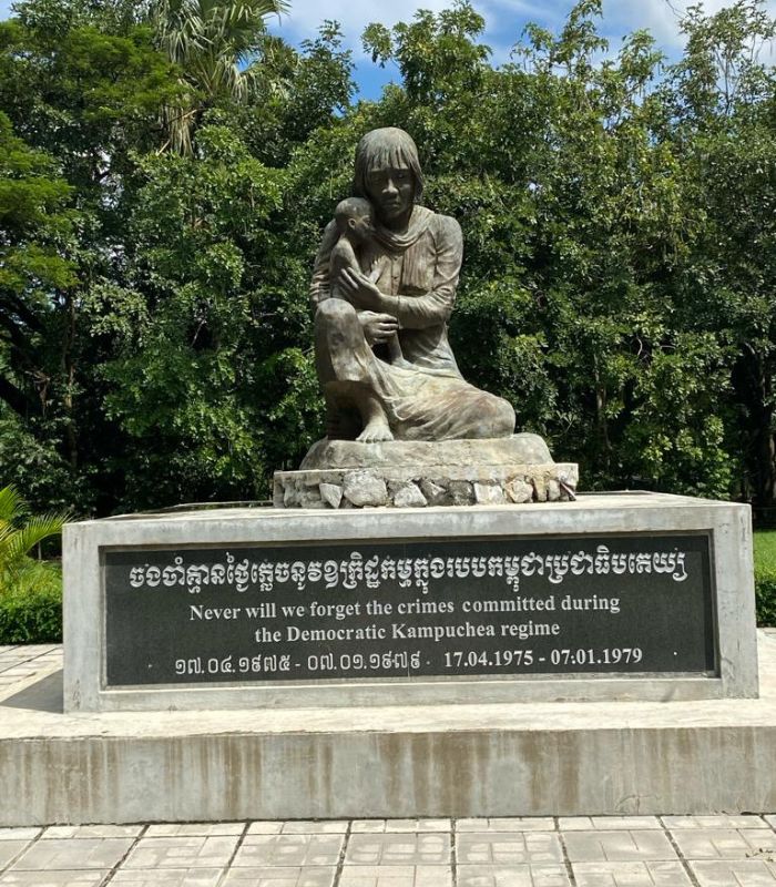 Statue of Mother and Child, Cambodia Dan by one of the engraved walls at Angkor Wat